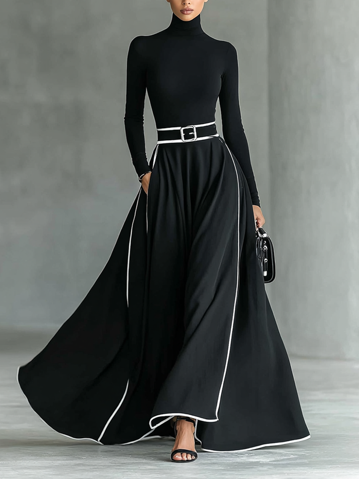 Martina – Abito maxi nero con cuciture bianche, collo alto, maniche lunghe e cintura