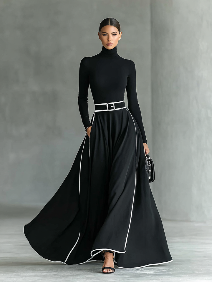 Martina – Abito maxi nero con cuciture bianche, collo alto, maniche lunghe e cintura