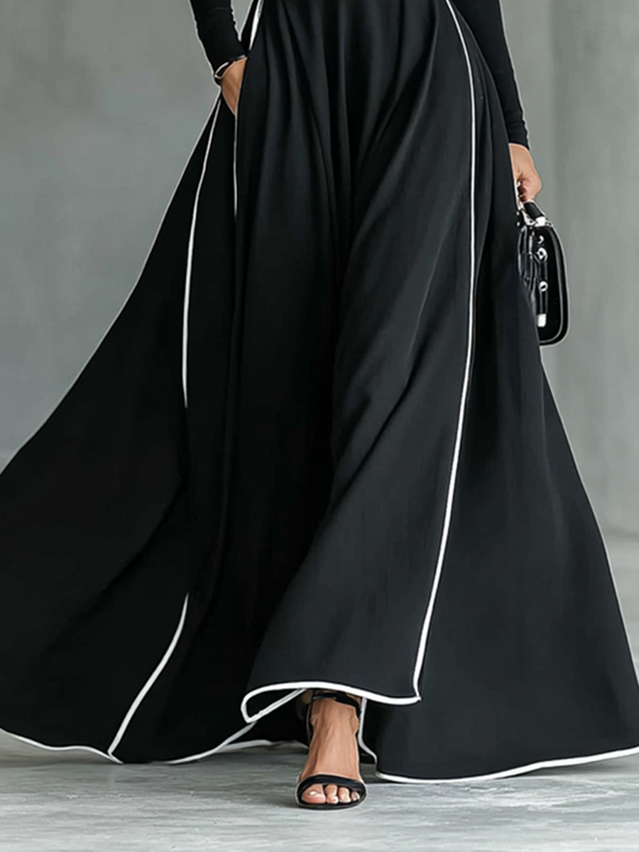 Martina – Abito maxi nero con cuciture bianche, collo alto, maniche lunghe e cintura